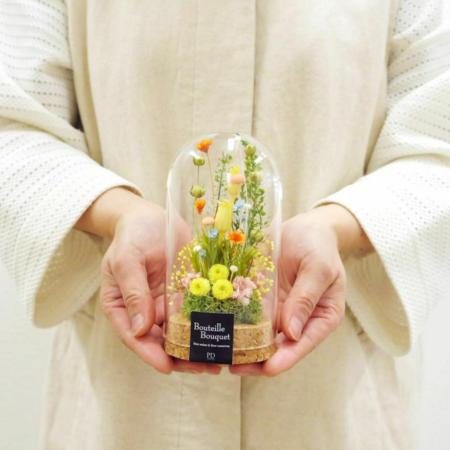 ガラスドームフラワーSサイズを手に持っている